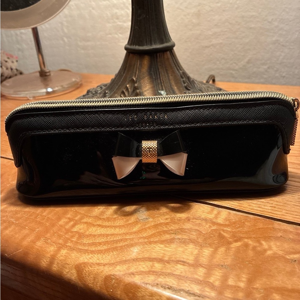 Ted Baker London Case. Stylish Black Patent Leather Bag with Bow Accent